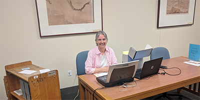 Image of Renee Meade reviewing archival documents